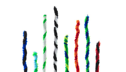 Twisted pipe cleaners in two tone twists, isolated on white, standing up like bar graphs.