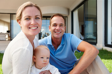 Obraz premium The beginning of our family tree. Outdoor portrait of a happy family relaxing on the grass.