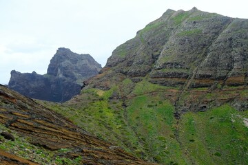 Ponta de Sao Lourenco (Saint Lawrence Peninsula) is the easternmost point on the Madeira map. A miracle of nature. Amazing colorful rocks. Silhouettes of people on trail. Madeira, Portugal