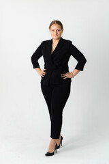 Fototapeta premium Confident businesswoman with folded arms standing looking at the camera over grey background