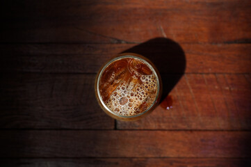 iced coffee with milk on a wooden board