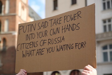 Hand made banner with slogan calling Russians to  take power in their own hands, during street...
