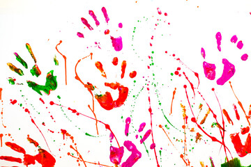 Multicolored handprints on a white wall. Drawing with paints by hands 