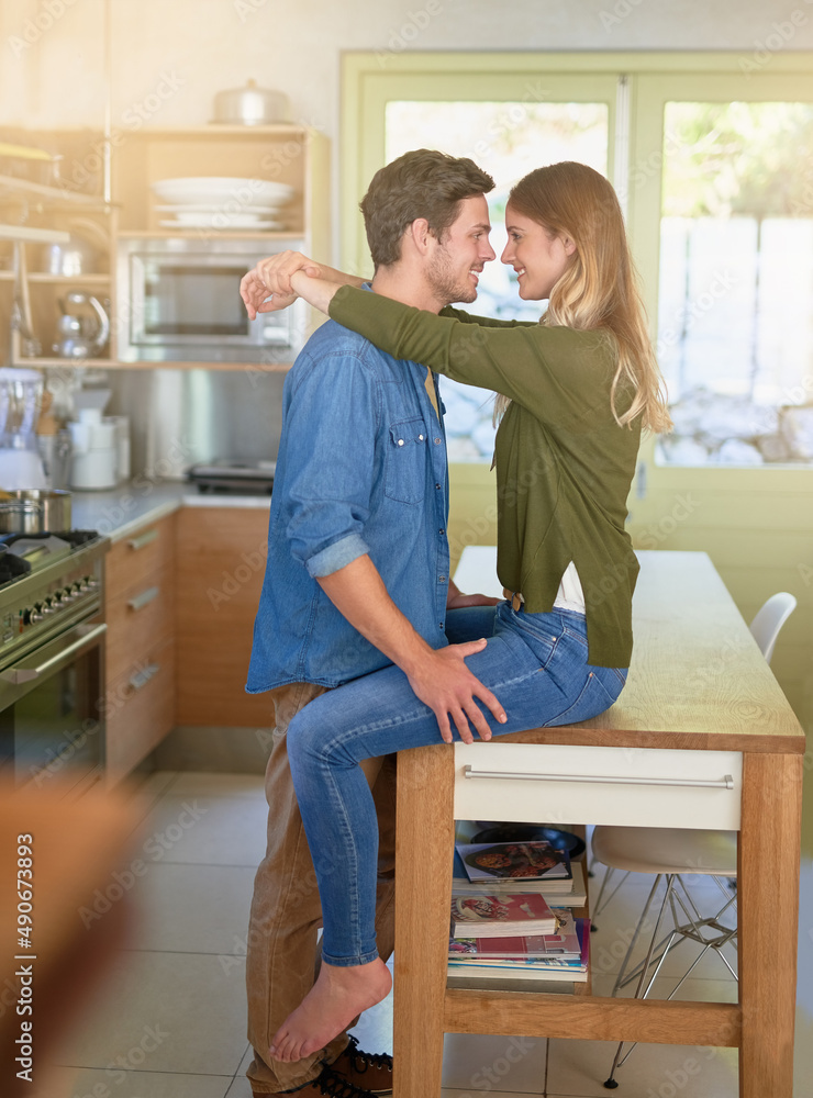 Canvas Prints Getting romantic in the kitchen. Shot of an affectionate young couple hugging in their kitchen.