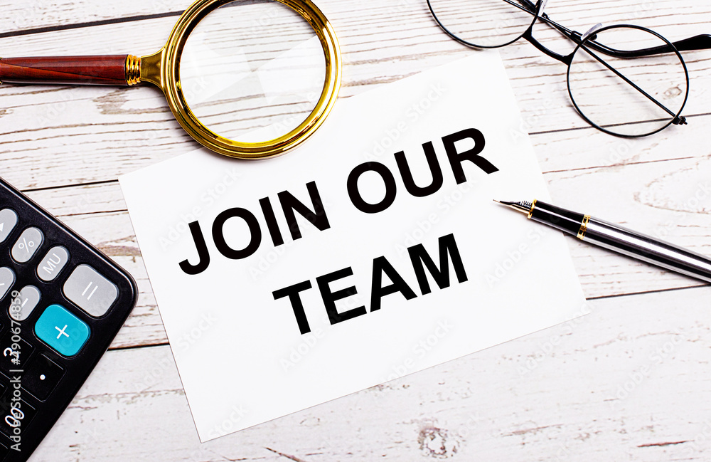 Poster workplace with business accessories and a white sheet of paper with the text join our team on a whit
