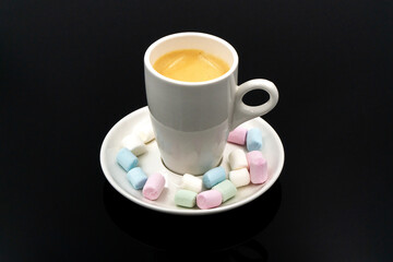 Coffee in white cups and small marshmallows. Turkish coffee, marshmallows on a dark background. Close-up. Two cups of coffee with marshmallows, coffee beans