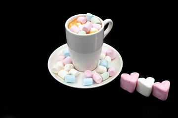 Coffee in white cups and small marshmallows. Turkish coffee, marshmallows on a dark background. Close-up. Two cups of coffee with marshmallows, coffee beans