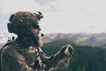 War concept. Bearded soldier in uniform of special forces in dangerous military action in dangerous...