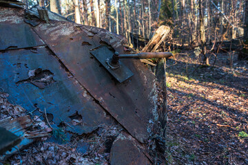 Old abandoned wooden fishing boat in the forest. Boat cemetery.