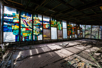 Colorful stained glass window inside an abandoned Pripyat cafe in Ukraine