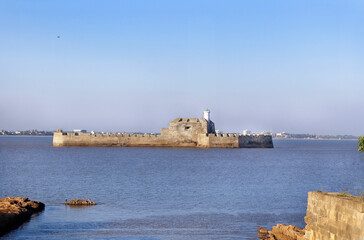 Pani Kotha prison in the distance. Shows the blue water, waves, ocean Walls of diu fort with view...