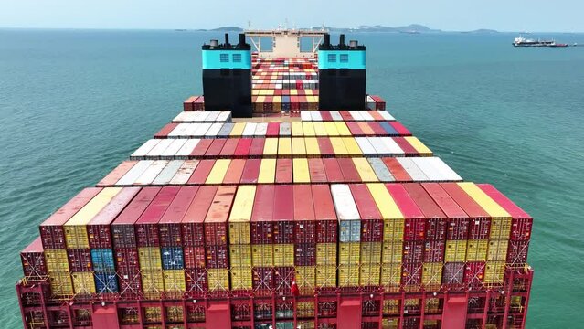 Stern of large cargo container ship import export container box on the ocean sea on blue sky back ground concept transportation logistic and service to customer and supply change