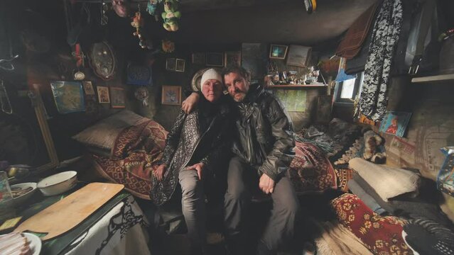 A homeless couple tells a story in their cabin.