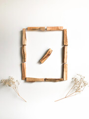 A set of wooden sticks Palo Santo on a white background. Aromatherapy and religious rites and meditations. Organic holy tree incense from Latin America top view