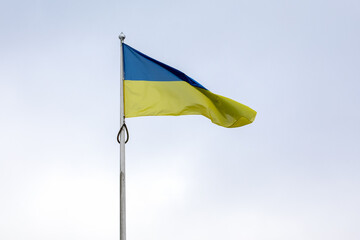 Ukrainian flag on the mast fluttering in the wind