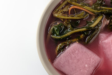red mustard greens watery Kimchi on a white background