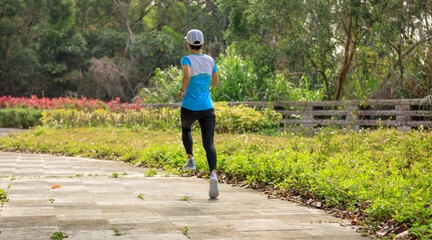 Fototapeta premium Asian woman jogging in park