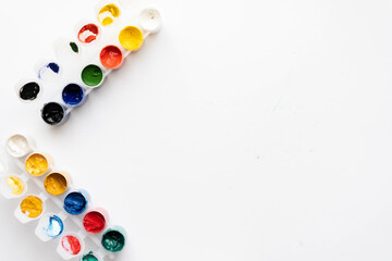 Top view paint, brushes and notepad for drawing. place under the text