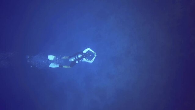 top view of man who swim with aqualung under water. Maldives