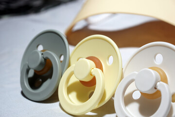 close-up of the new yellow baby pacifier, silicone nipple. A pacifier is also called a dummy or binocular, or a pacifier or teether. The concept of child care.
