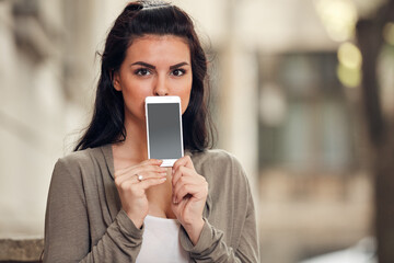 Fototapeta premium Young cute female using smartphone on the street.