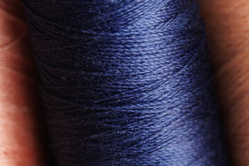 Sewing thread blue color macro shot.