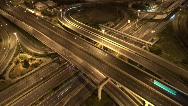 4K : Hyperlapse or Dronelapse Top view of Highway road junctions. The Intersection freeway road overpass the eastern outer ring road. Time lapse Aerial view 
