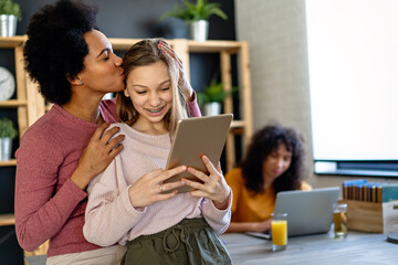 Happy multiethnic family using digital devices for online study. E-learning education people concept