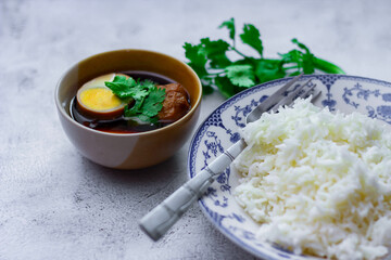 Steamed rice in an ancient plate and Stewed Eggs, Thai food and street food that are common in Thailand.