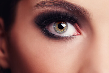Fototapeta premium Bright eyes. Closeup portrait of a beautiful young woman in the studio.