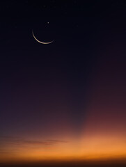 Naklejka na ściany i meble Crescent moon on dusk sky twilight vertical in the evening symbol religion of Islamic well editing text Ramadan Kareem, Eid Al Fitr, Eid Mubarak, Eid Al Adha on free space background
