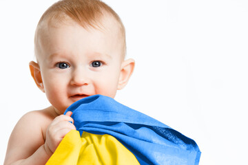 A small boy with national symbols in his hand. Ukrainian flag. Russia's invasion of Ukraine,...