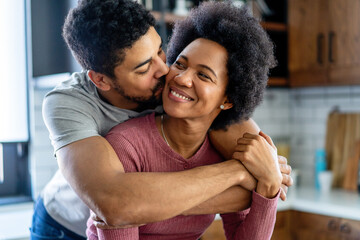 Obraz premium Portrait of happy smiling black couple in love having fun and hugging together