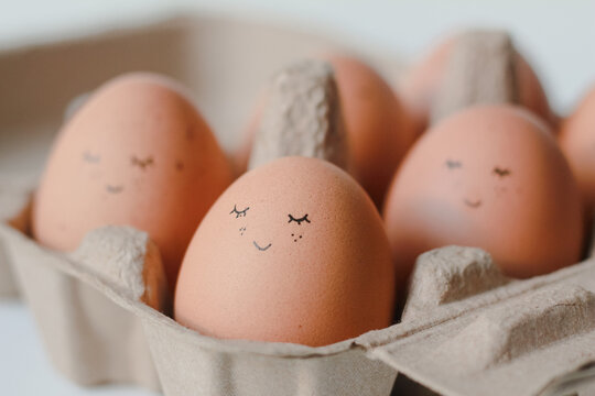 Smiley face on egg in egg box.Happy easter egg concept.