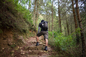 Obraz premium One backpacker man travel alone, with backpack in the mountains 