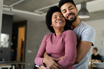 Obraz premium Portrait of happy smiling black couple in love having fun and hugging together