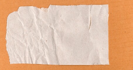 Kraft torn and creased Paper on cardboard Background	