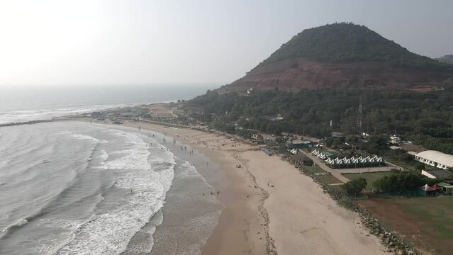 Rushikonda Beach vishakhapattnam
mountain sea shore drone shot birds eye view India green tress and beautiful sea Sunrise