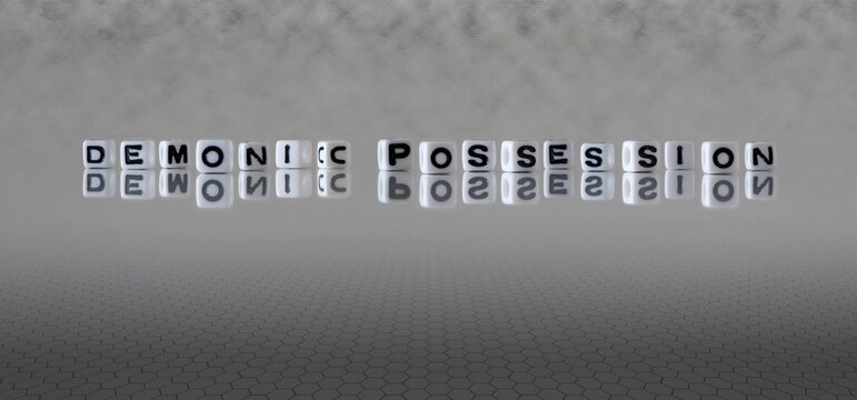 Demonic Possession Word Or Concept Represented By Black And White Letter Cubes On A Grey Horizon Background Stretching To Infinity