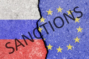 The crack between the Russian Federation and European Union flags. The concept of sanctions.
