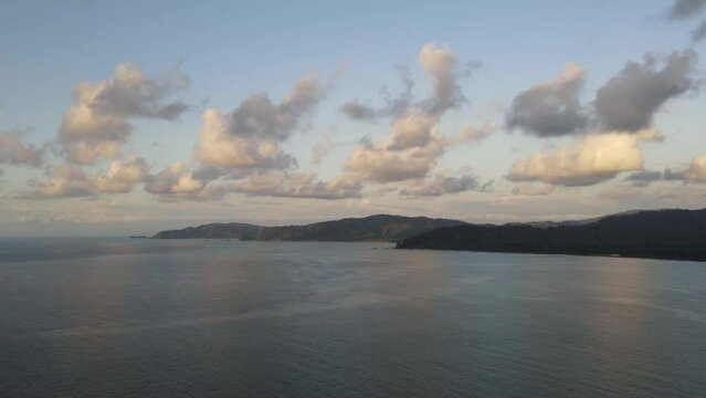 Beautiful hyper lapse of Costa Rica coast during a sunset. Clouds passing in the blue sky. Nice contrast between the sunset and the tropical forest