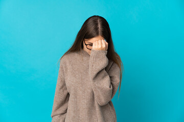 Young Lithuanian woman isolated on blue background with headache