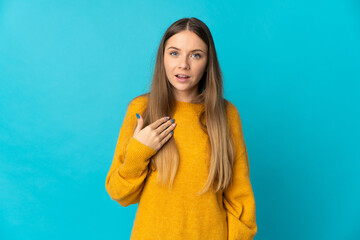 Young Lithuanian woman isolated on blue background pointing to oneself