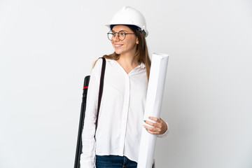 Young Lithuanian architect woman with helmet and holding blueprints isolated on white background...