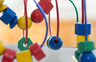 colored blocks on a spiral - circle Bead Maze - educational toy for children, background in the theme of child development