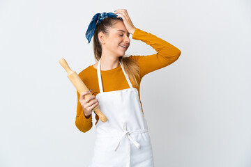 Fototapeta na wymiar Young Lithuanian woman holding a rolling pin isolated on white background smiling a lot