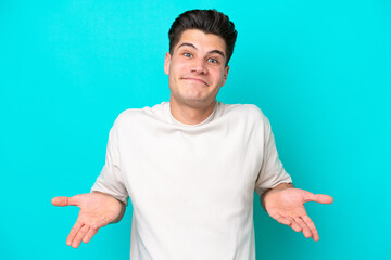 Young handsome caucasian man isolated on blue bakcground happy and smiling