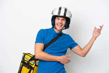 Young caucasian man with thermal backpack isolated on white background making guitar gesture