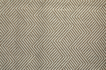 Knitted texture. Texture of jacquard fabric with gray beige geometric pattern. Crochet mosaic pattern.