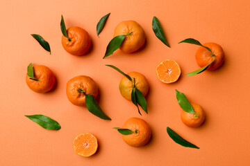 Many fresh ripe mandarin as colored background, top view. Elegant background of clementines and mandarin slices Top view flat lay